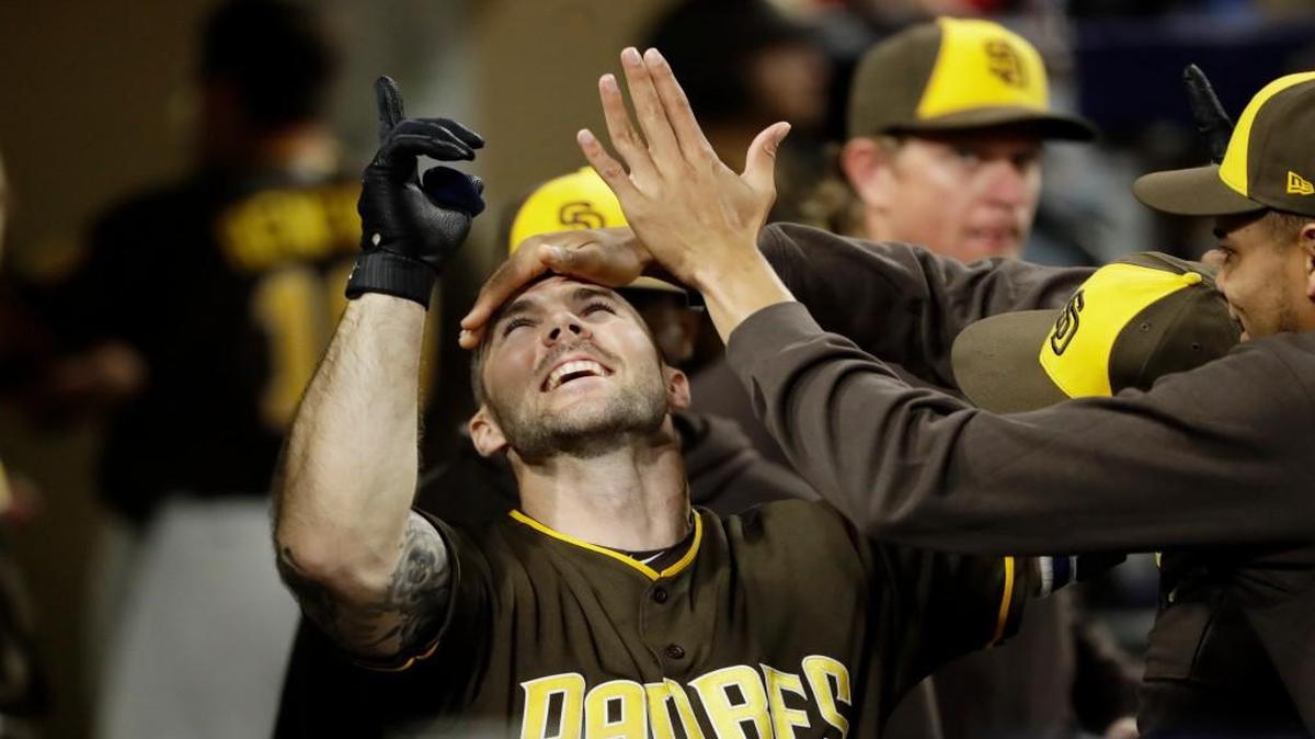 San Diego Padres' Matt Szczur is greeted by teammates in the dugout after hitting a home run during the seventh inning against the Kansas City Royals on Friday.