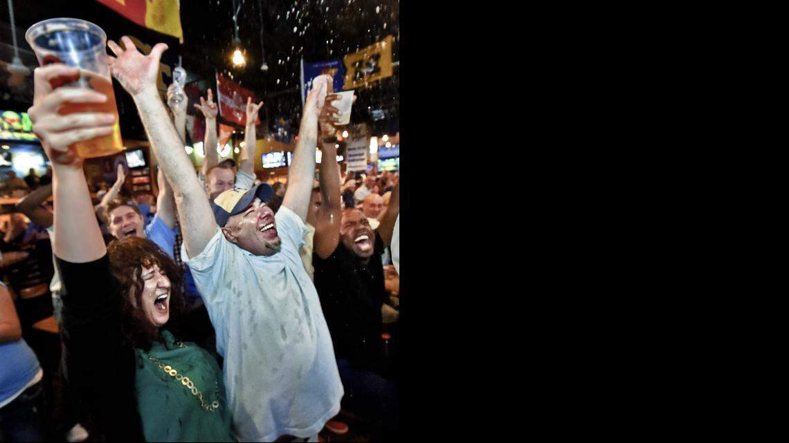 
Jonnae Hill and Mick Kirst, both of Kansas City, celebrate Friday at Johnny’s Tavern at the Power & Light District after watching the Royals beat the White Sox 3-1 and make the playoffs for the first time since 1985.
