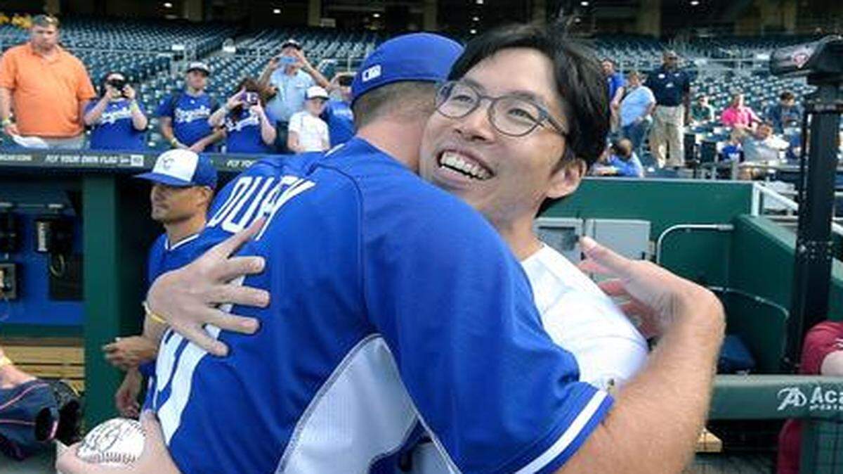
Royals fan SungWoo Lee from South Korea gives Royals pitcher Danny Duffy a hug after they met before Monday's baseball game against the Athletics at Kauffman Stadium.
