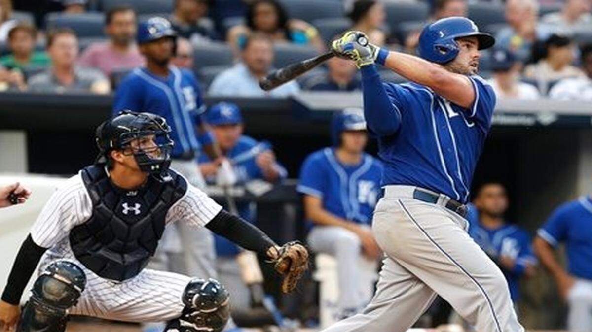 
Kansas City Royals' Mike Moustakas hits a sacrifice fly during the sixth inning of the baseball game against the New York Yankees at Yankee Stadium, Saturday, Sept. 6, 2014 in New York. 
