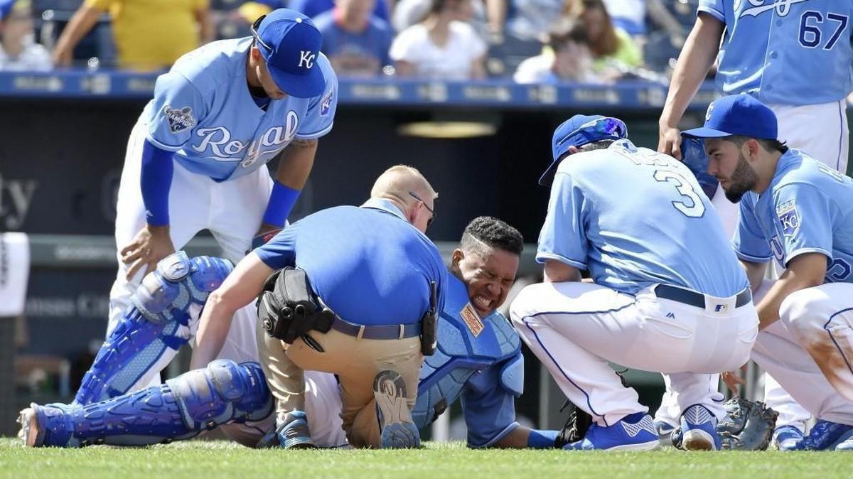Royals catcher Salvador Perez is checked on before leaving the game after he and third baseman Cheslor Cuthbert collided chasing a foul ball in the ninth inning during Saturday’s baseball game against the Chicago White Sox at Kauffman Stadium.