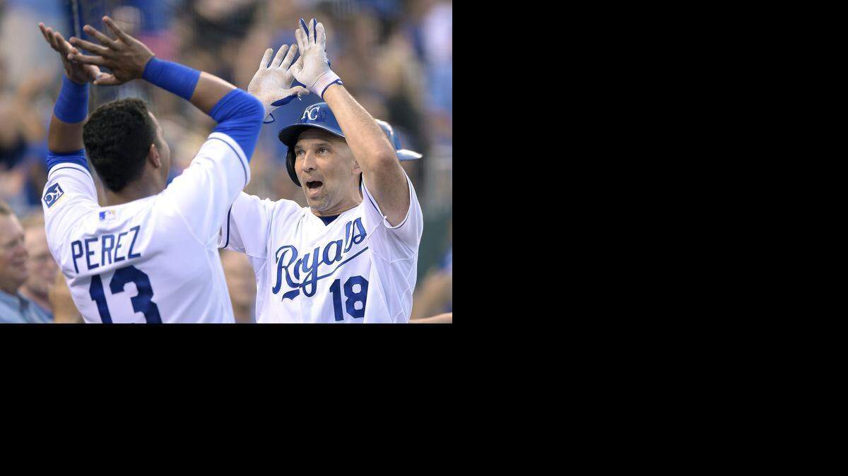 
Kansas City Royals' Raul Ibanez (18) is greeted by Salvador Perez (13) after Ibanez scored on his triple and a throwing error by Cleveland Indians second baseman Jason Kipnis in the fourth inning during Friday's baseball game on July 25, 2014, at Kauffman Stadium in Kansas City, Mo.

