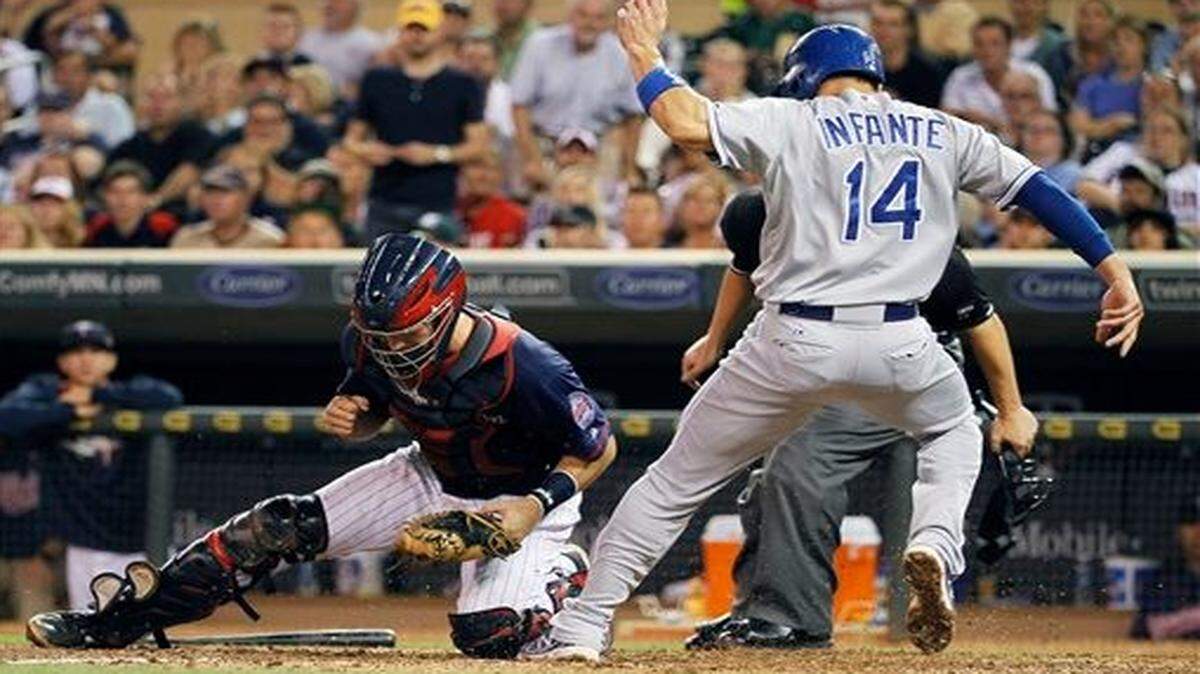 
The Royals' Omar Infante scored on a single by Billy Butler as Twins catcher Eric Fryer dropped the throw from center during the fifth inning of Monday’s baseball game in Minneapolis.
