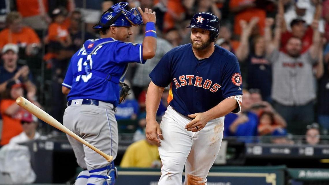 Astros designated hitter Evan Gattis tossed his bat after drawing a bases-loaded walk off Kansas City reliever Matt Strahm to score George Springer and win the game against the Royals in 12 innings on Sunday in Houston.
