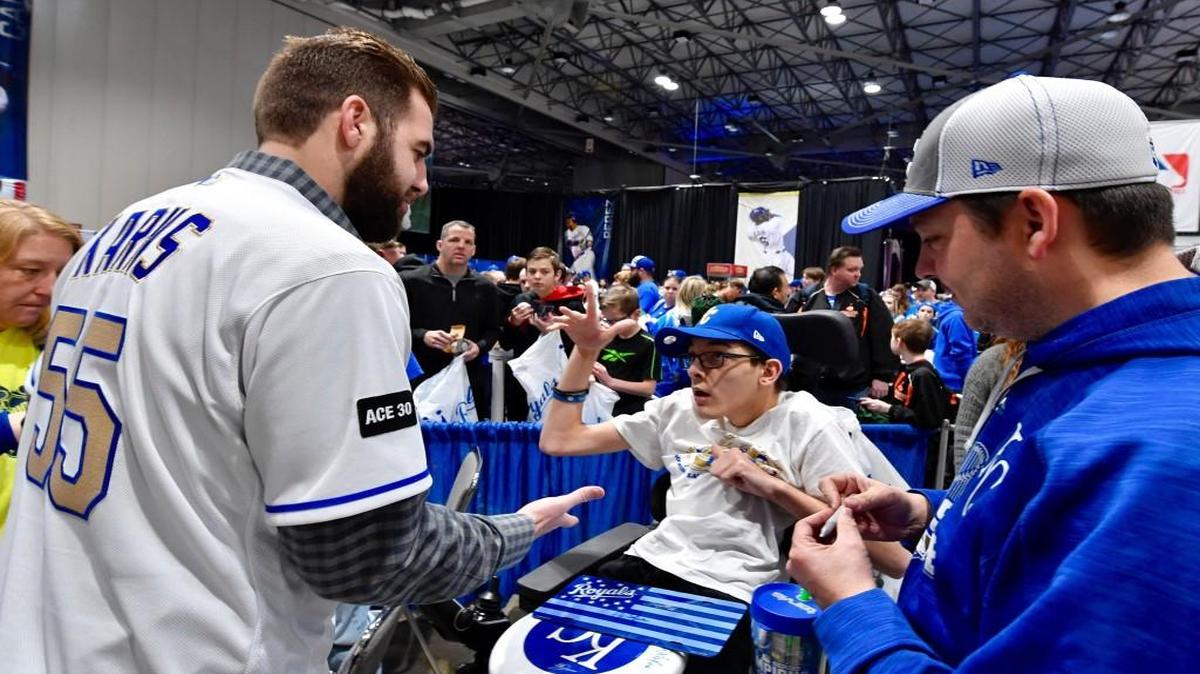Pitcher Nathan Karns high-fives Nathan Leeker at an autograph session during Saturday’s Royals FanFest at Bartle Hall in Kansas City, Mo.