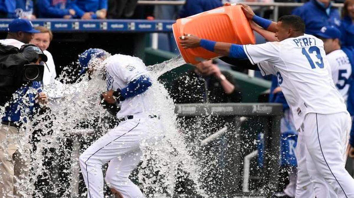
Kansas City Royals catcher Salvador Perez doused Kansas City Royals right fielder Alex Rios with a bucket of ice water after the Royals’ 10-1 victory Monday over the White Sox at Kauffman Stadium. Rios was three for four, including a three-run homer.
