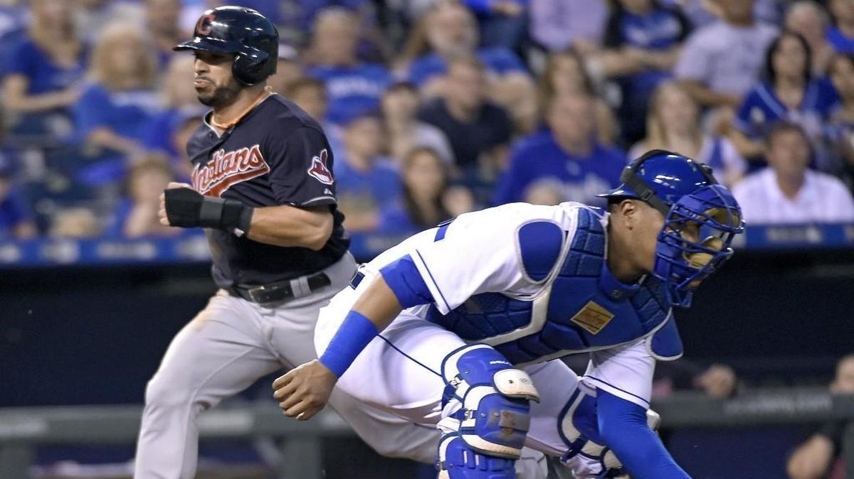 
The Indians’ Mike Aviles (4) scored behind Royals catcher Salvador Perez on a triple by Jose Ramirez in the fourth inning Saturday night at Kauffman Stadium in Kansas City.
