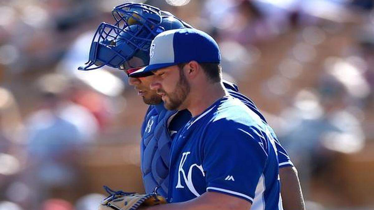 
Brandon Finnegan, the 21-year-old left-hander, will shift into a role as a starter, with either the Naturals or with Class-AAA Omaha. His performance this spring eased the decision for the Royals. With an 8.53 Cactus League ERA, shaky command and an equilibrium jolted by his first spring training, Finnegan lacked a credible case for the big-league bullpen. Finnegan (foreground) talked with catcher Salvador Perez while pitching Saturday against the Chicago White Sox in Surprise, Ariz.
