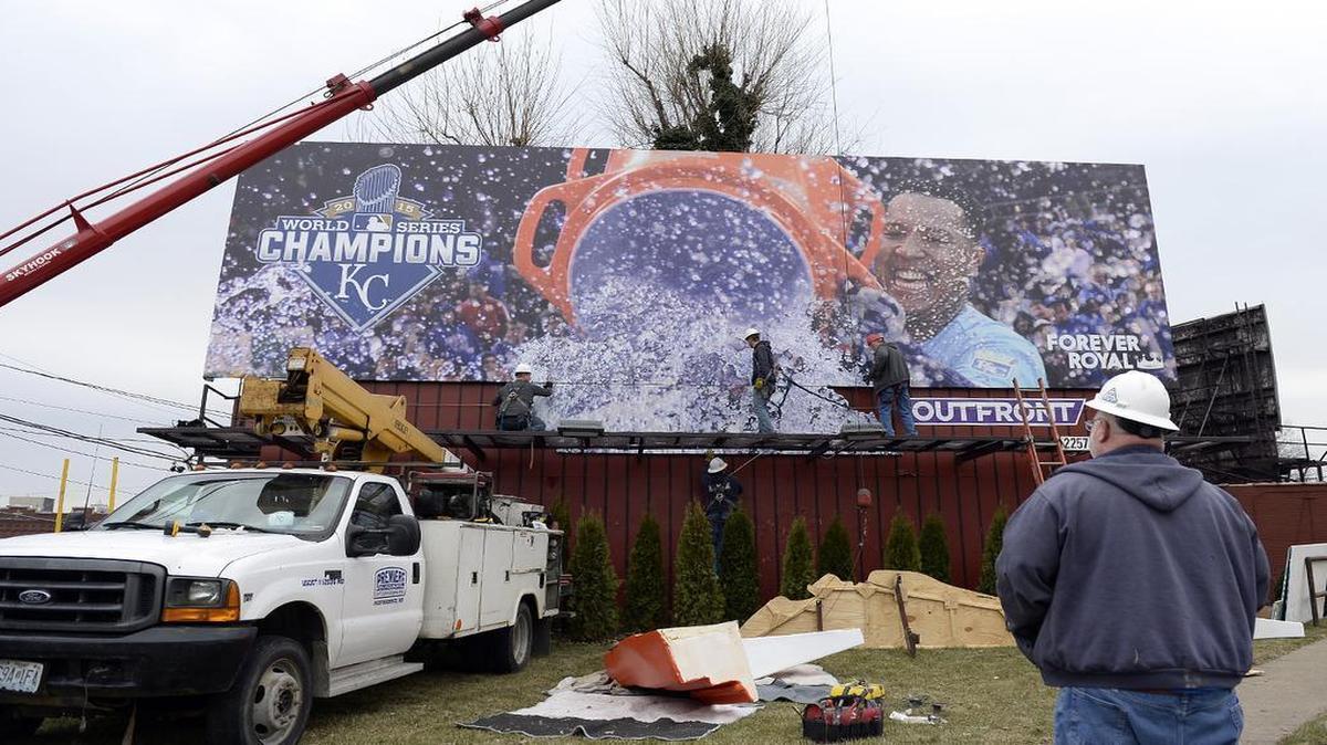 Workers finish installation of the Royals’ 2016 billboard featuring catcher Salvador Perez’s water cooler and the slogan “Forever Royal” at the northeast corner of Southwest Trafficway and Westport Road.