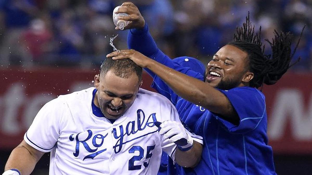 
Royals pitcher Johnny Cueto (right) doused teammate Kendrys Morales (25) in celebration after Morales hit the game-winning single to score Ben Zobrist in the 10th inning for a 4-3 win over the Los Angeles Angels on Sunday night at Kauffman Stadium.
