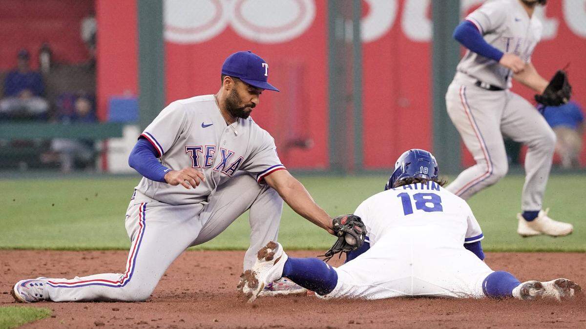 Texas Rangers second baseman Marcus Semien (2) misses the tag as Kansas City Royals’ Nate Eaton (18) steals second base in the fourth inning on April 17, 2023, at Kauffman Stadium.