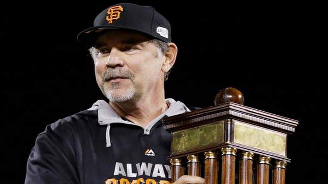 
“Bruce Bochy’s unmatched skill at managing postseason games pushes the opposition to the breaking point, time and again,” Ann Killion of the San Francisco Chronicle writes of the Giants’ skipper. Bochy held the 2014 National League championship trophy after his team beat the St. Louis Cardinals.
