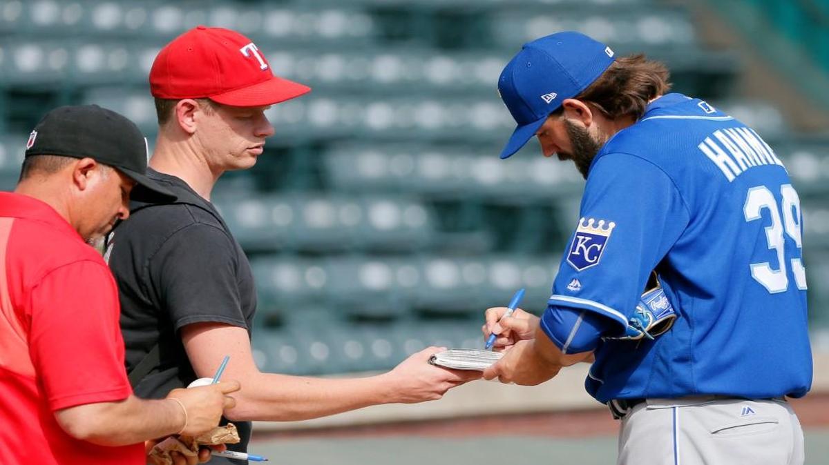 Kansas City Royals starting pitcher Jason Hammel signs autographs for fans before a baseball game against the Texas Rangers in Arlington, Texas, Friday, April 21, 2017.