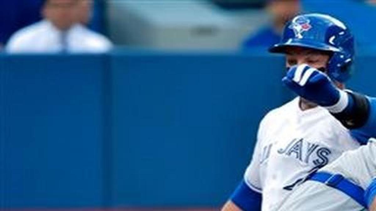 
Blue Jays shortstop Troy Tulowitzki scores at home plate past Royals catcher Perez Salvador during the first inning of Thursday’s baseball game in Toronto. 
