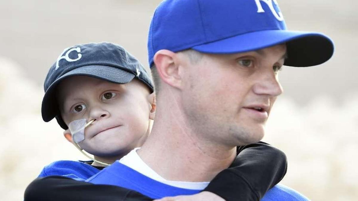 
Noah Wilson, the Olathe boy whose fight against cancer and passion for the Royals made him a celebrity during Kansas City’s run to the 2014 World Series, died Tuesday night at age 7. Noah had Ewing’s sarcoma, a rare form of bone cancer. He is pictured with his father, Scott, before game two of the World Series between the Royals and San Francisco Giants last October.
