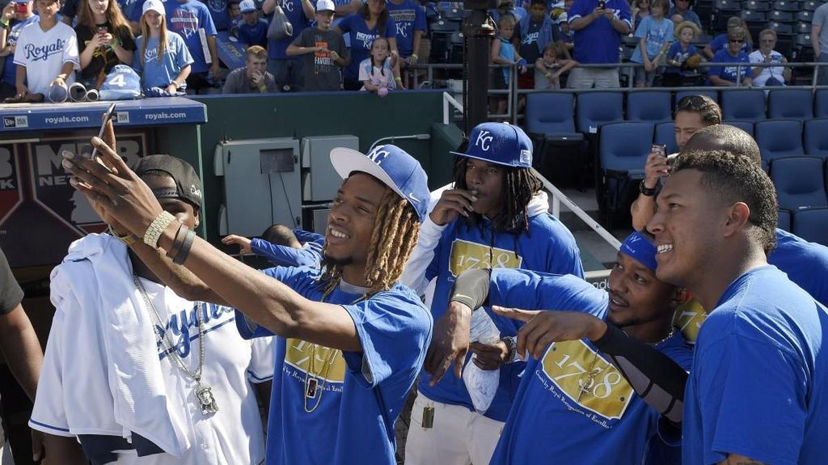 Rapper Fetty Wap poses for a selfie with Kansas City Royals' Salvador Perez (13) and Jarrod Dyson (1) before the game against the Detroit Tigers on August 11, 2015 at Kauffman Stadium in Kansas City, Mo.