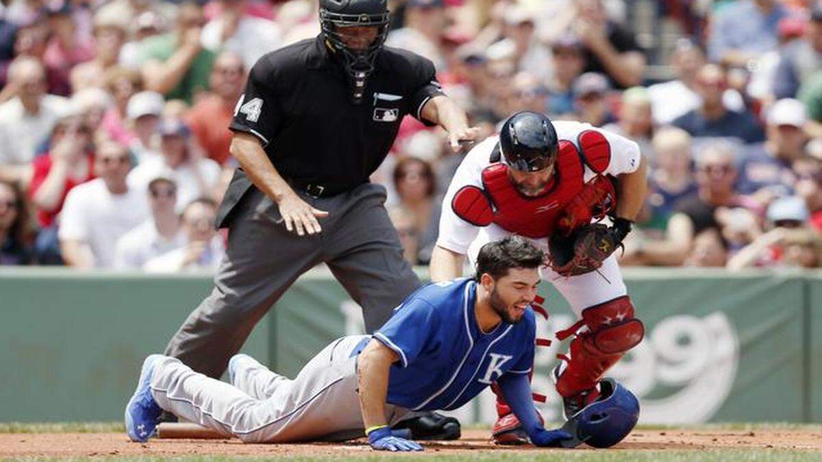 
Boston Red Sox catcher David Ross, right, and umpire Kerwin Danley reach out to Kansas City Royals first baseman Eric Hosmer after he was hit by a pitch during the first inning of a baseball game in Boston on Sunday, July 20, 2014.
