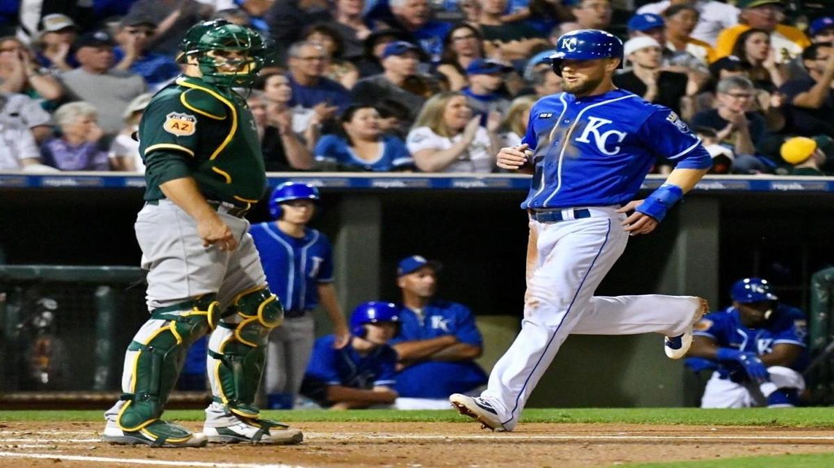 Kansas City’s Alex Gordon scores on a triple by Lorenzo Cain against the Oakland Athletics during Friday’s spring training baseball game in Surprise, Ariz.