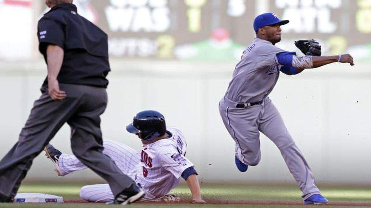 
The Twins' Kurt Suzuki was forced out at second by Royals shortstop Alcides Escobar on a fielders choice hit into by Joe Mauer during Monday’s game in Minneapolis. Escobar's throw to first was late. (AP Photo/Jim Mone)
