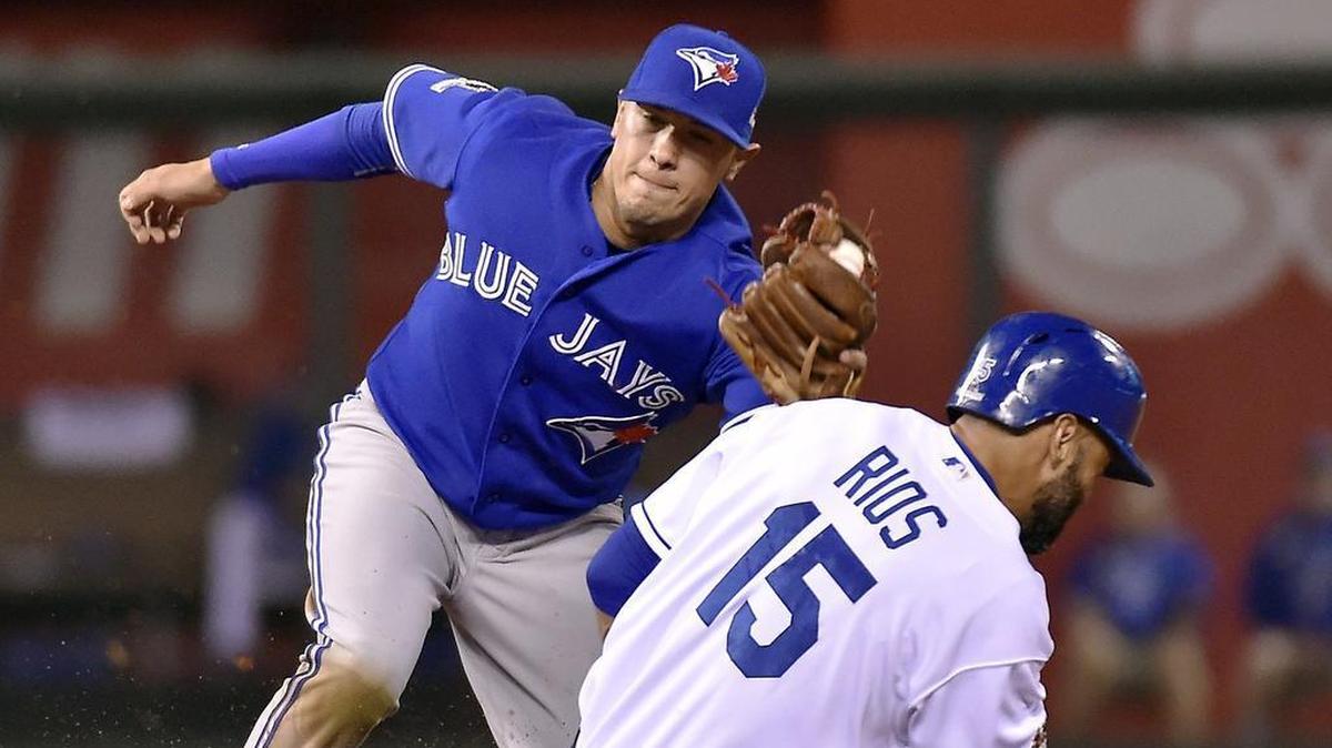 Kansas City Royals right fielder Alex Rios beat the tag of Toronto Blue Jays second baseman Ryan Goins in the fifth inning of Game 6 of the 2015 AL Championship Series at Kauffman Stadium.