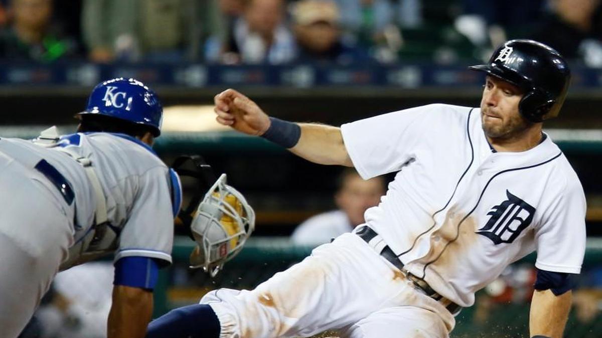 
Royals catcher Salvador Perez dove back to the plate to tag out the Tigers’ Ian Kinsler in the ninth inning Saturday night in Detroit. Kinsler at first was ruled safe, but the call was overturned after a replay review.
