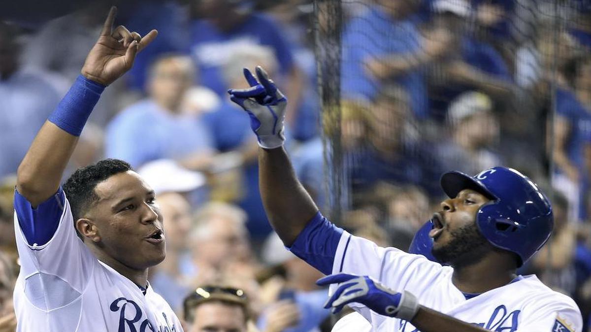 
Salvador Perez (left) helped Lorenzo Cain celebrate Cain’s solo home run in the third inning, the second of four homers by the Royals in a drubbing of the Tigers on Wednesday at Kauffman Stadium.
