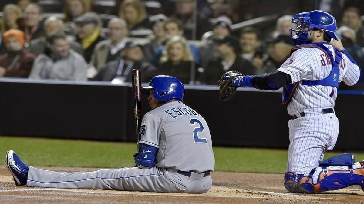 Kansas City Royals shortstop Alcides Escobar sat on the ground after dodging the first pitch by New York Mets starting pitcher Noah Syndergaard in the first inning of Game 3 of the World Series on Friday at Citi Field in New York.