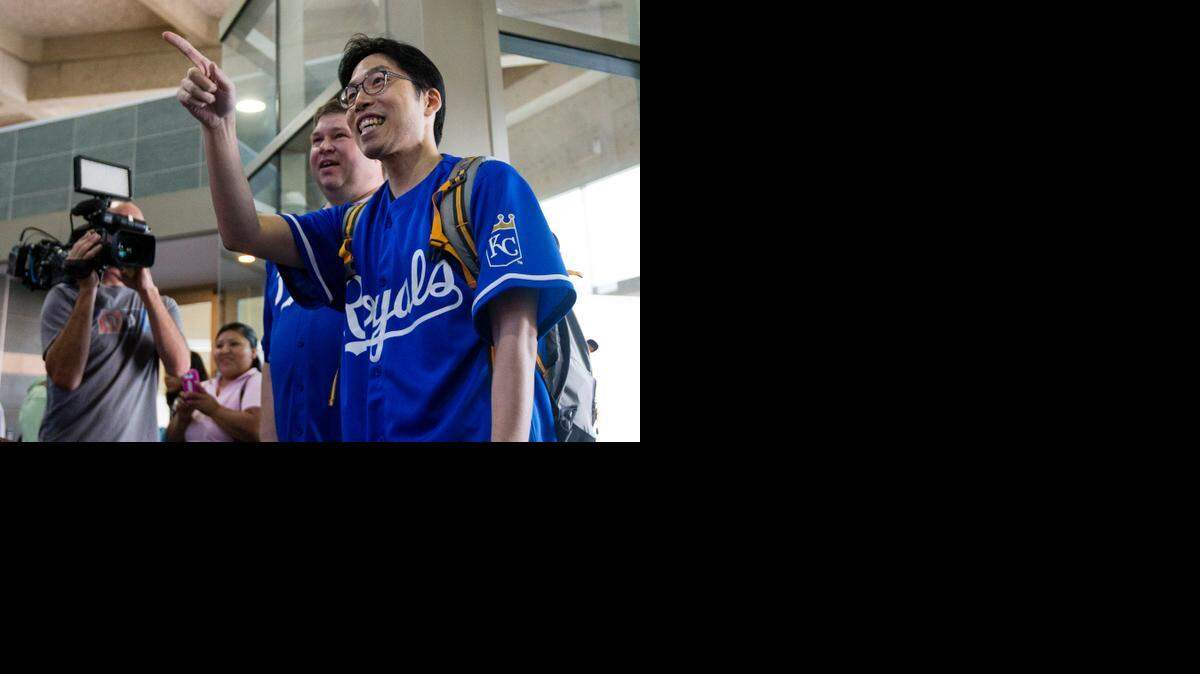 
Sung Woo Lee (right) waved to his welcoming party at Kansas City International Airport. He is a major Royals fan from South Korea and came to Kansas City to see his first Royals game.
