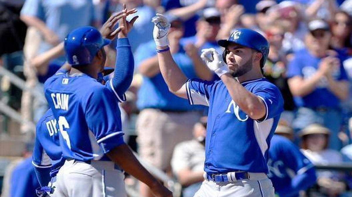 
Teammates welcomed Eric Hosmer (right) at home plate after he hit a three-run homerun in the first inning of Kansas City’s 13-2 victory over the Texas Ranagers on Wednesday in Surprise, Ariz., Kansas City’s first game of spring training.
