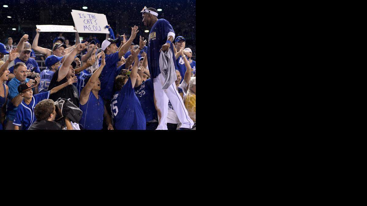
Kansas City Royals center fielder Jarrod Dyson (1) celebrated on top of the dugout with fans after the Kansas City Royals beat the Oakland Athletics during the Wild Card game on Oct. 1 at Kauffman Stadium.
