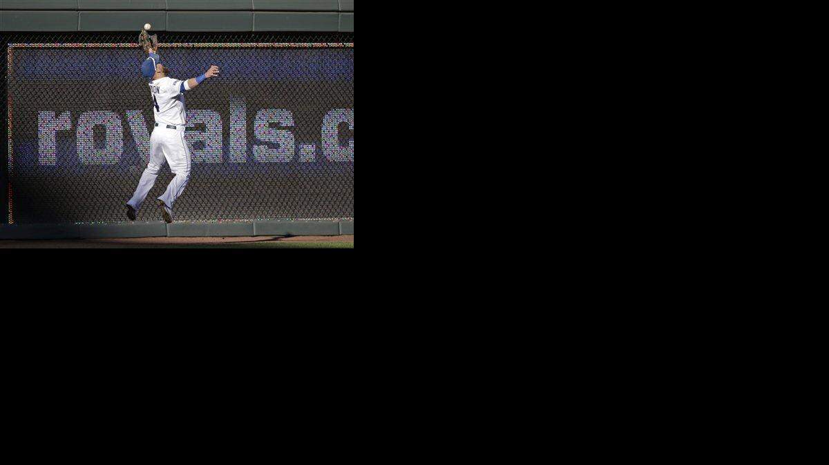 
Kansas City Royals left fielder Alex Gordon leaps to make a catch on a ball hit by Baltimore Orioles' J.J. Hardy in the fifth inning of Game 4 of the American League baseball championship series Wednesday in Kansas City.
