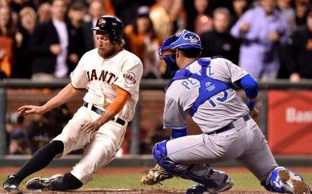 
San Francisco’s Hunter Pence, who opened the second inning with a single that led to a score, beat the tag from Royals catcher Salvador Perez in game five of the World Series on Sunday.
