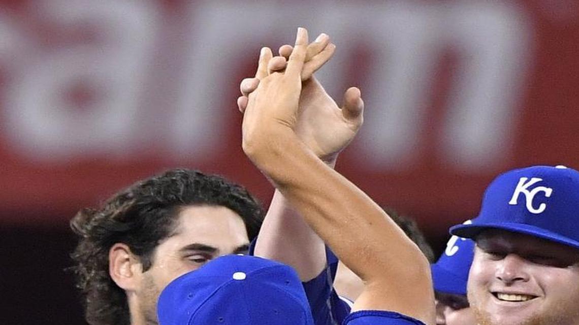 Royals relief pitcher Brooks Pounders (right) was congratulated on his first major league win after the team’s 4-3 victory over the Seattle Mariners on Thursday night.
