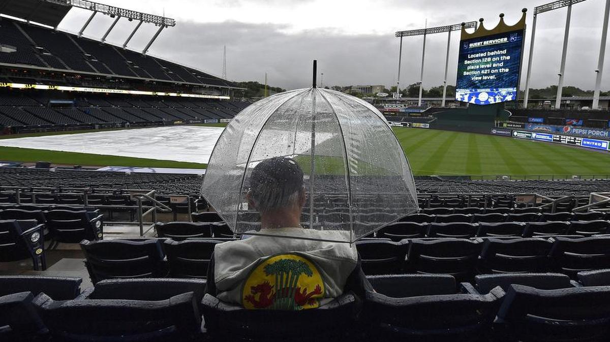 A fan waited for the announcement that Saturday’s baseball game between the Kansas City Royals and Seattle Mariners was officially rained out at Kauffman Stadium in Kansas City, Mo. The two teams will play a double header on Sunday.
