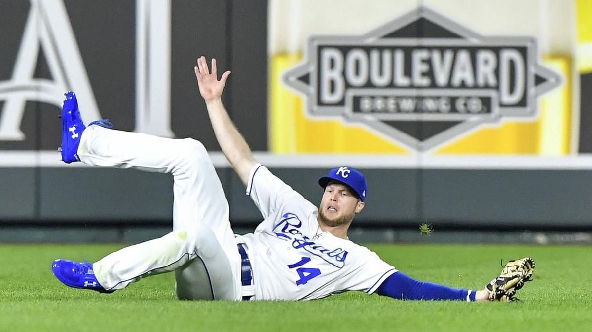 Royals center fielder Brett Phillips slides across the grass after catching a line drive by Toronto’s Luke Maile last season.