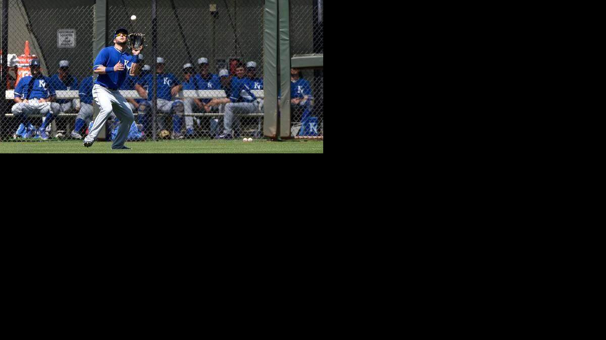 
Kansas City Royals left fielder Alex Gordon (4) catches a fly ball in front of the bullpen during the Kansas City Royals and Texas Rangers spring training baseball game at Surprise Stadium on Monday, March 30, 2015, in Surprise, Arizona.
