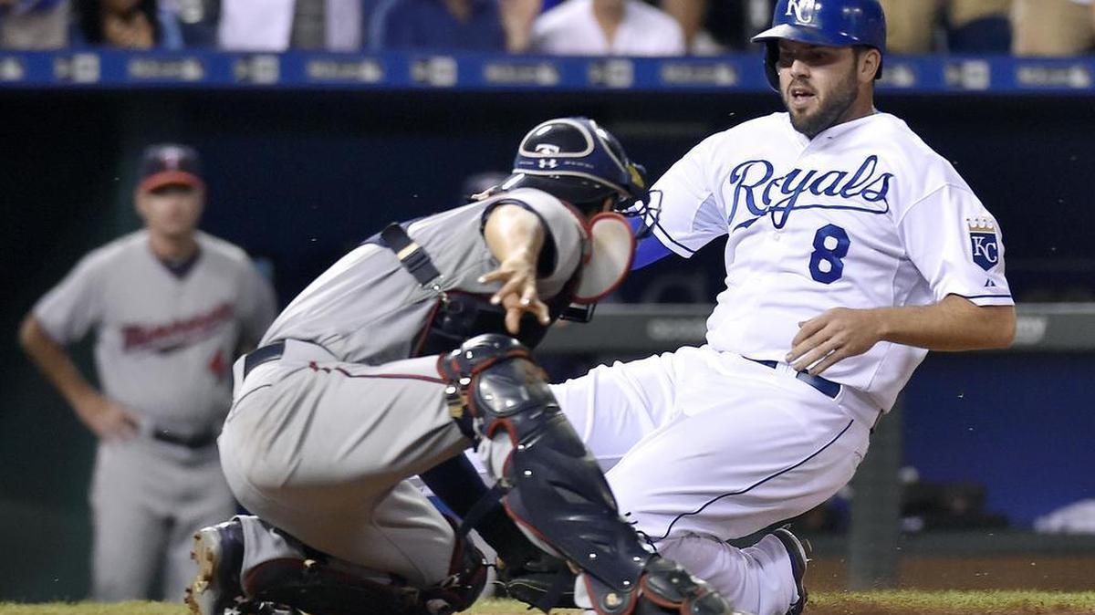 
Kansas City Royals' Mike Moustakas (8) is tagged out at the plate by Minnesota Twins catcher Kurt Suzuki (8) trying to score on a hit by Paulo Orlando to end the seventh inning during Monday's baseball game on September 7, 2015 at Kauffman Stadium in Kansas City, Mo.
