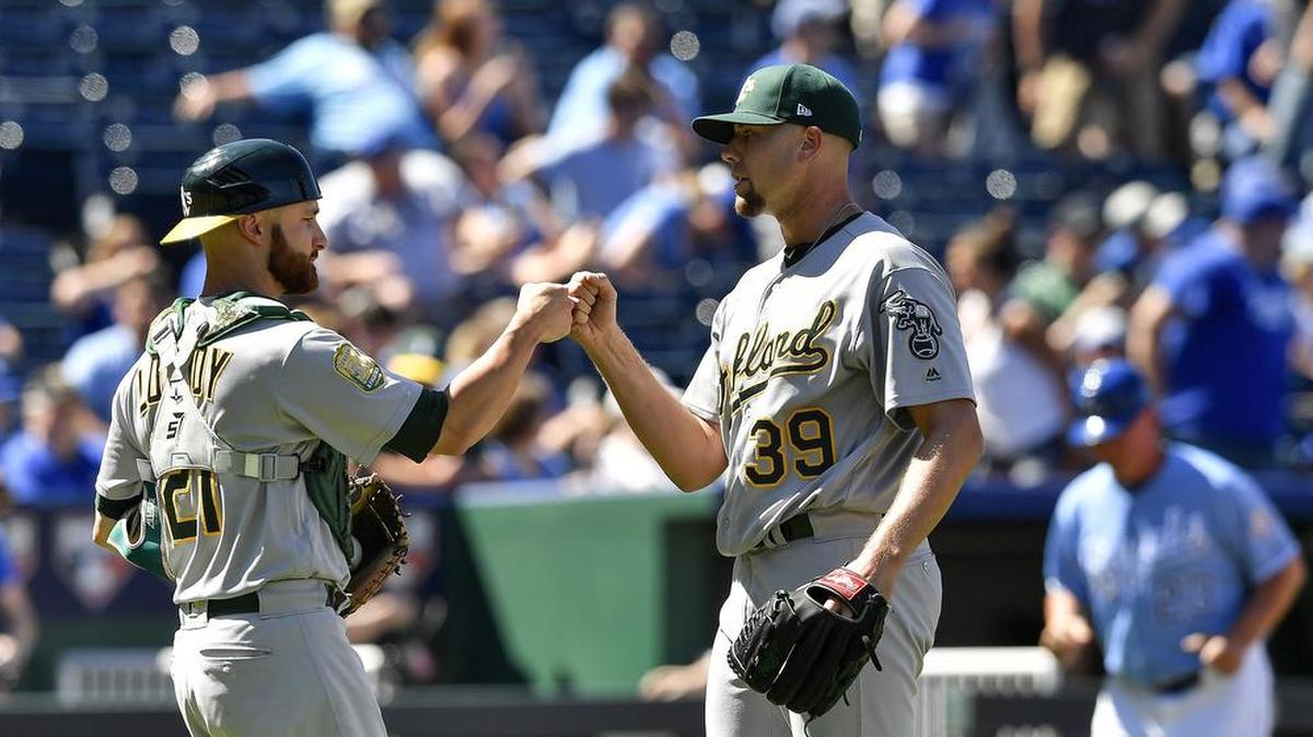 Oakland reliever Blake Treinen, right, celebrates with A's catcher Jonathan Lucroy after closing out the ninth inning of a 5-1 win over the Royals last month at Kauffman Stadium.