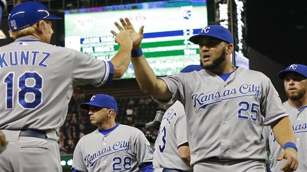
Kansas City Royals designated hitter Kendrys Morales, right, high-fives first base coach Rusty Kuntz after the Royals defeated the Minnesota Twins 3-1 in a baseball game, Monday, June 8, 2015, in Minneapolis. Morales hit a two-run home run off Twins pitcher Phil Hughes in the second inning. (AP Photo/Jim Mone)
