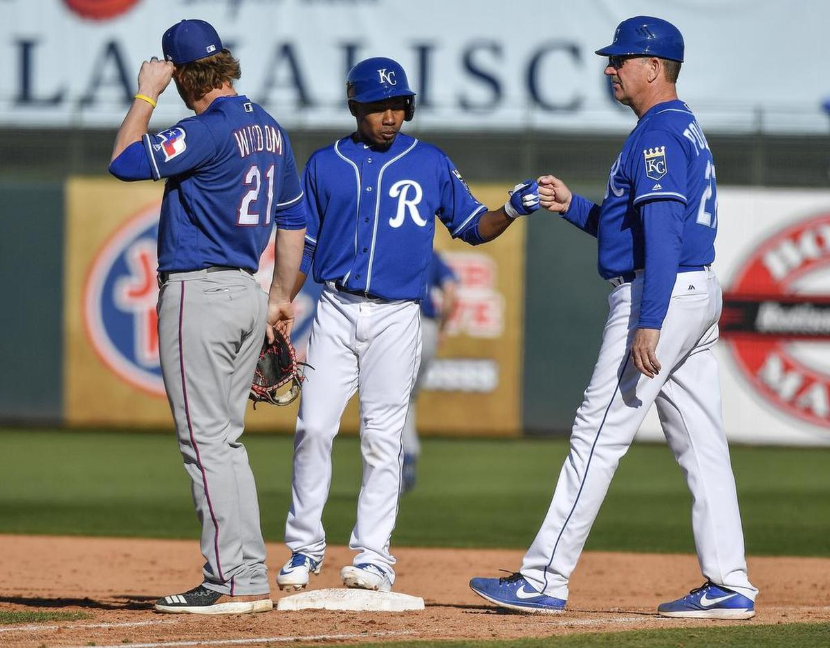 Kansas City Royals’ Terrance Gore is greeted by first base coach Brian Poldberg after Gore reached on a single in the eighth inning during Saturday’s spring training baseball game against the Texas Rangers on February 23, 2019 at Surprise Stadium in Surprise, AZ.