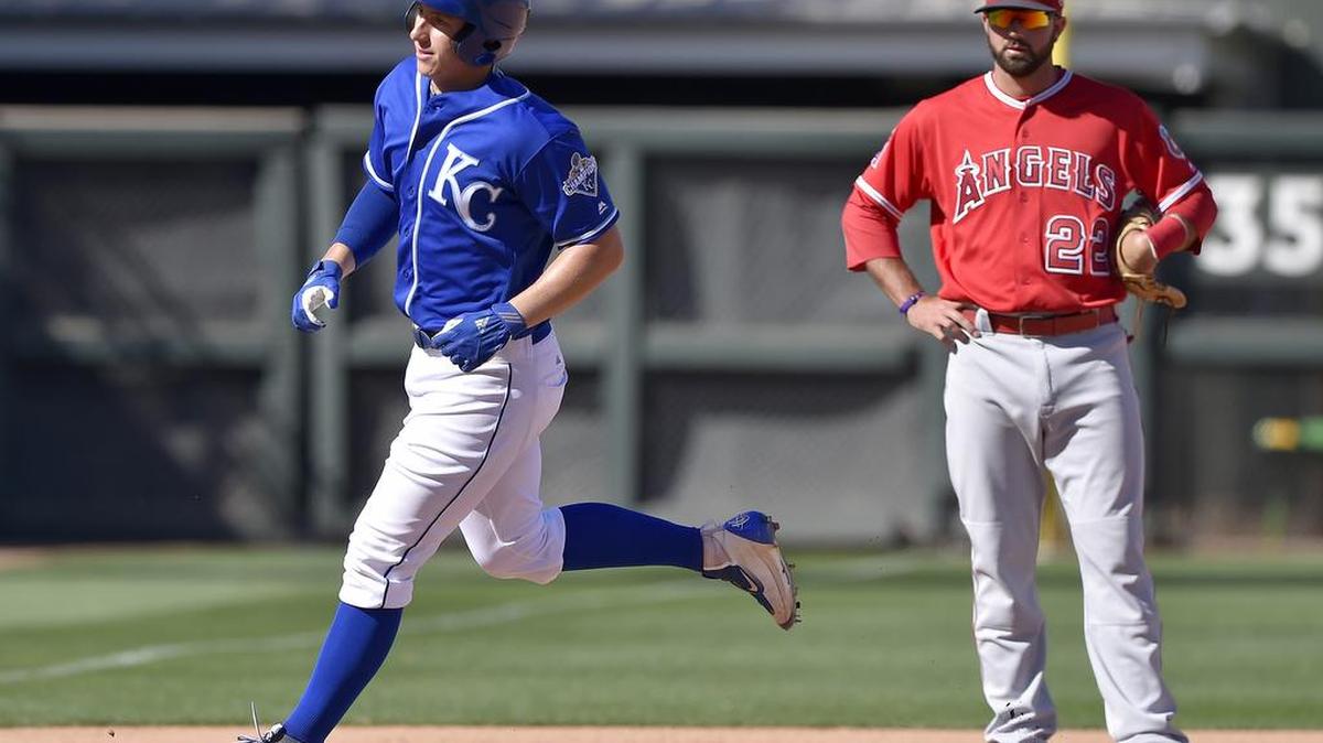 Kansas City Royals' Frank Schwindel rounds the bases in front of Los Angeles Angels' Kaleb Cowart on a two run home run in the eighth inning during Friday's spring training baseball game on March 18, 2016 in Surprise, Ariz.