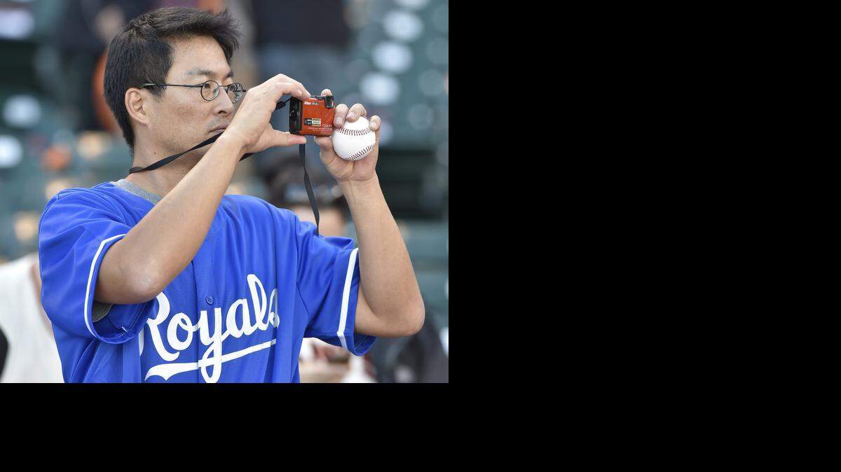 
A Kansas City Royals fan was making sure to remember this moment as he took pictures during batting practice prior to the start of game three of the World Series on Friday, October 24, 2014 at AT&T Park in San Francisco, Calif.
