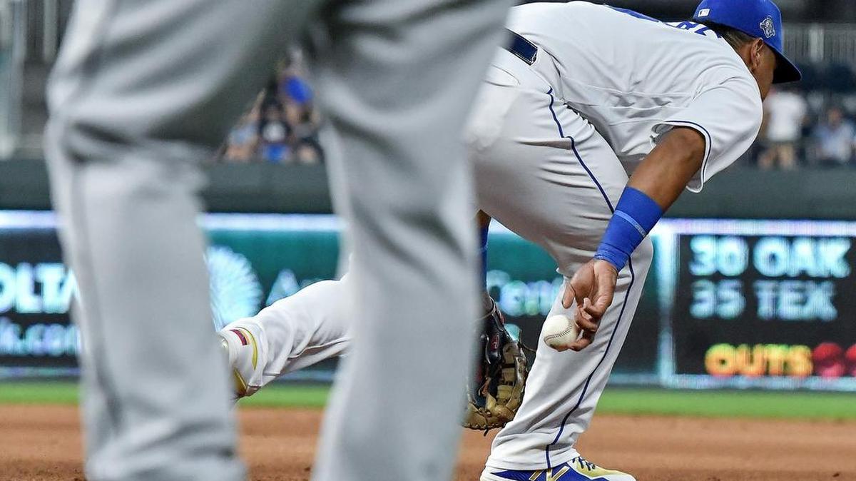Kansas City Royals Salvador Perez flips the ball behind him at first base to relief pitcher Heath Fillmyer in time to catch Detroit Tigers’ Jim Adduci at first on a ground out in the fifth inning during Monday’s baseball game on July 23, 2018, at Kauffman Stadium in Kansas City, Mo.