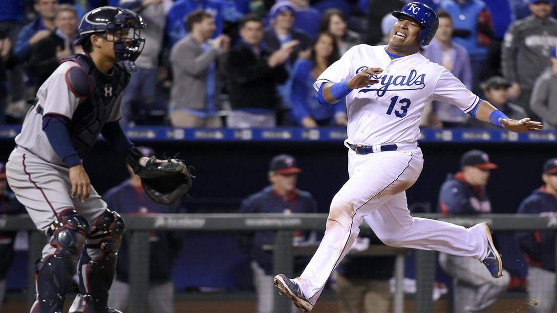 Salvador Perez scored in front of Minnesota Twins catcher Kurt Suzuki on a triple by Paulo Orlando in the eighth inning Monday at Kauffman Stadium.
