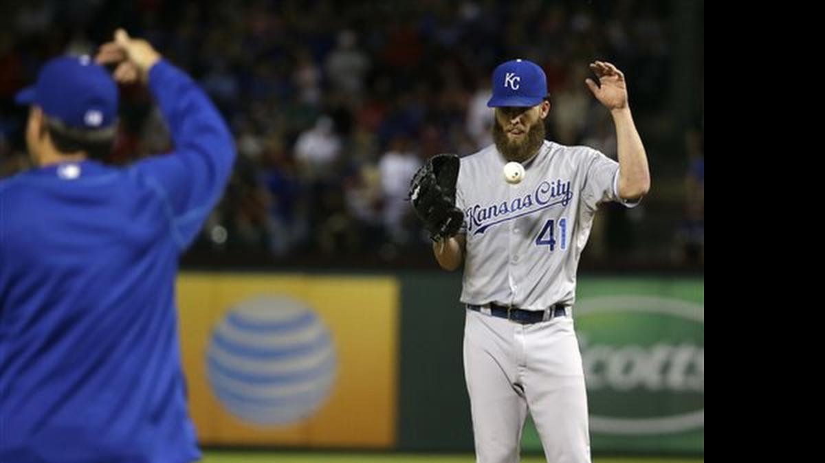 
Royals pitcher Danny Duffy tossed the ball as manager Ned Yost walked to the mound to put in a new pitcher during the fourth inning against the Texas Rangers on Monday in Arlington, Texas.