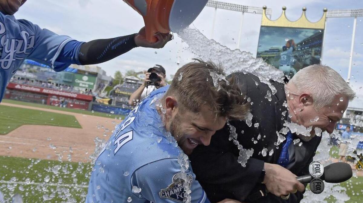 As Kansas City Royals' Salvador Perez delivers the Gatorade shower, Drew Butera holds onto Fox Sports KC broadcaster Joel Goldberg after the teams 6-1 win over the Baltimore Orioles during Sunday's baseball game on April 24, 2016 at Kauffman Stadium in Kansas City, Mo.