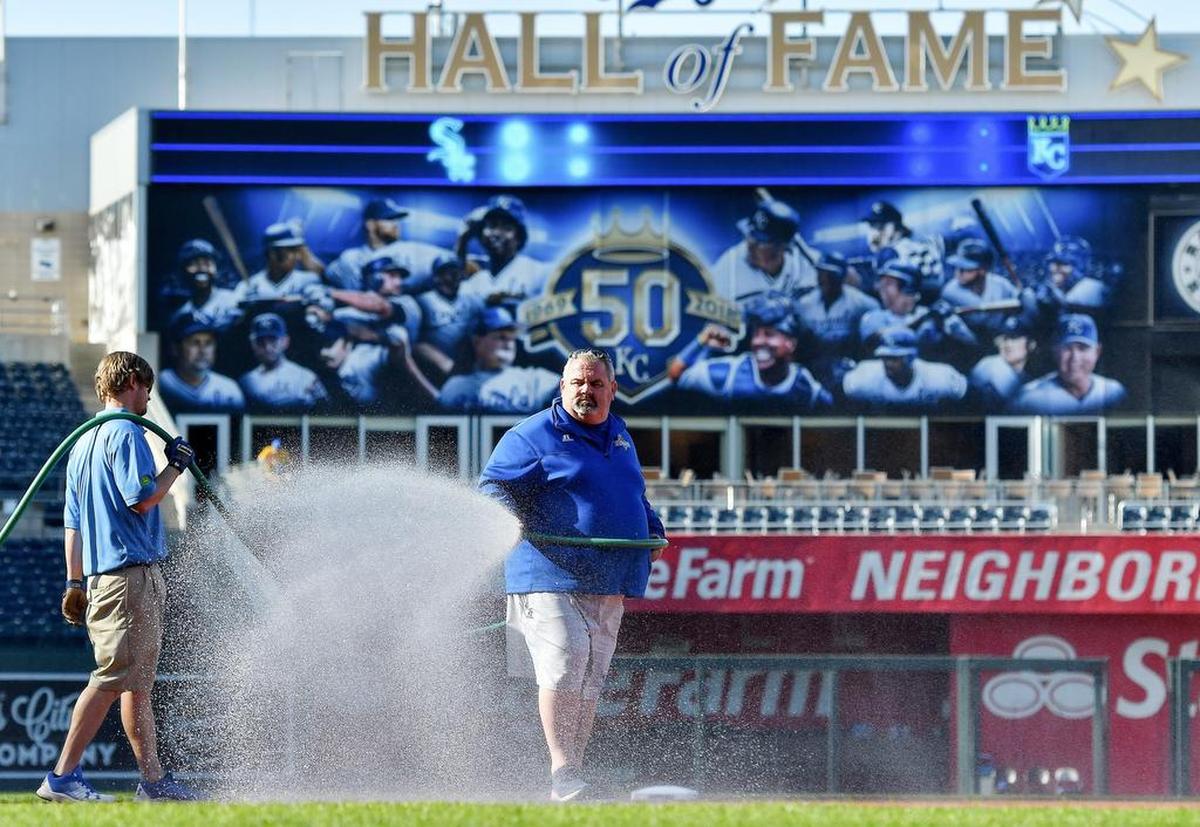 Kansas City Royals head groundskeeper Trevor Vance waters the infield before Saturday’s second baseball game of a doubleheader against the Chicago White Sox on April 28, 2018, at Kauffman Stadium in Kansas City, Mo.