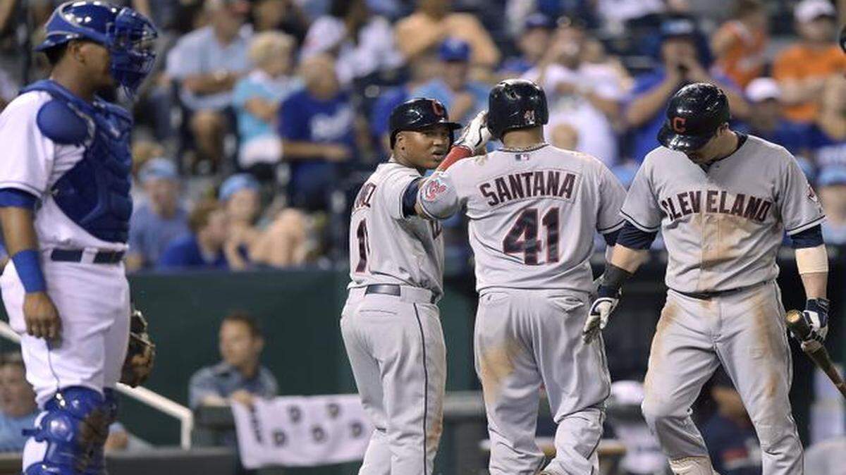 
Kansas City Royals catcher Salvador Perez (13) waits as Cleveland Indians' Carlos Santana (41) is congratulated after hitting a two run home run in the ninth inning during Friday's baseball game on August 29, 2014, at Kauffman Stadium in Kansas City, Mo.

