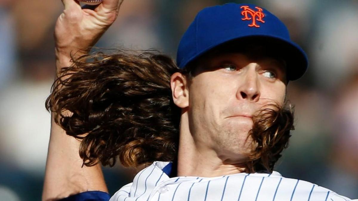 The flowing hair of Mets pitcher Jacob deGrom sometimes gets in his face while he is pitching.