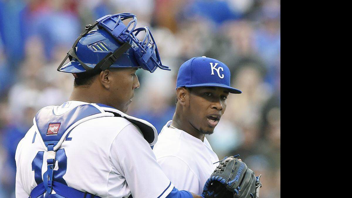 
Kansas City Royals catcher Salvador Perez (13) holds back starting pitcher Yordano Ventura (30) after hitting Oakland Athletics' Brett Lawrie with a pitch in the fourth inning and being ejected during Saturday's baseball game on April 18, 2015 at Kauffman Stadium in Kansas City, Mo.
